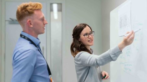 man and woman at whiteboard choosing business name