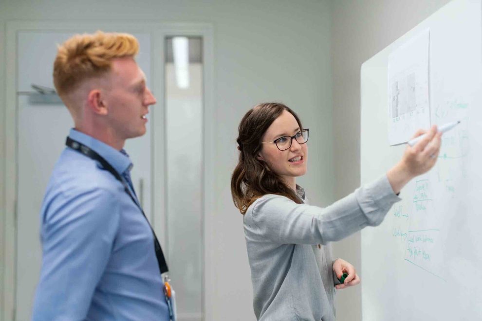 man and woman at whiteboard choosing business name