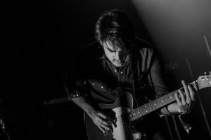 Music NFT artist playing guitar