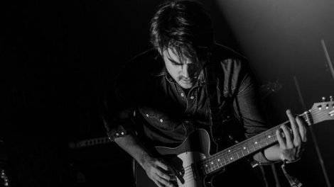 Music NFT artist playing guitar